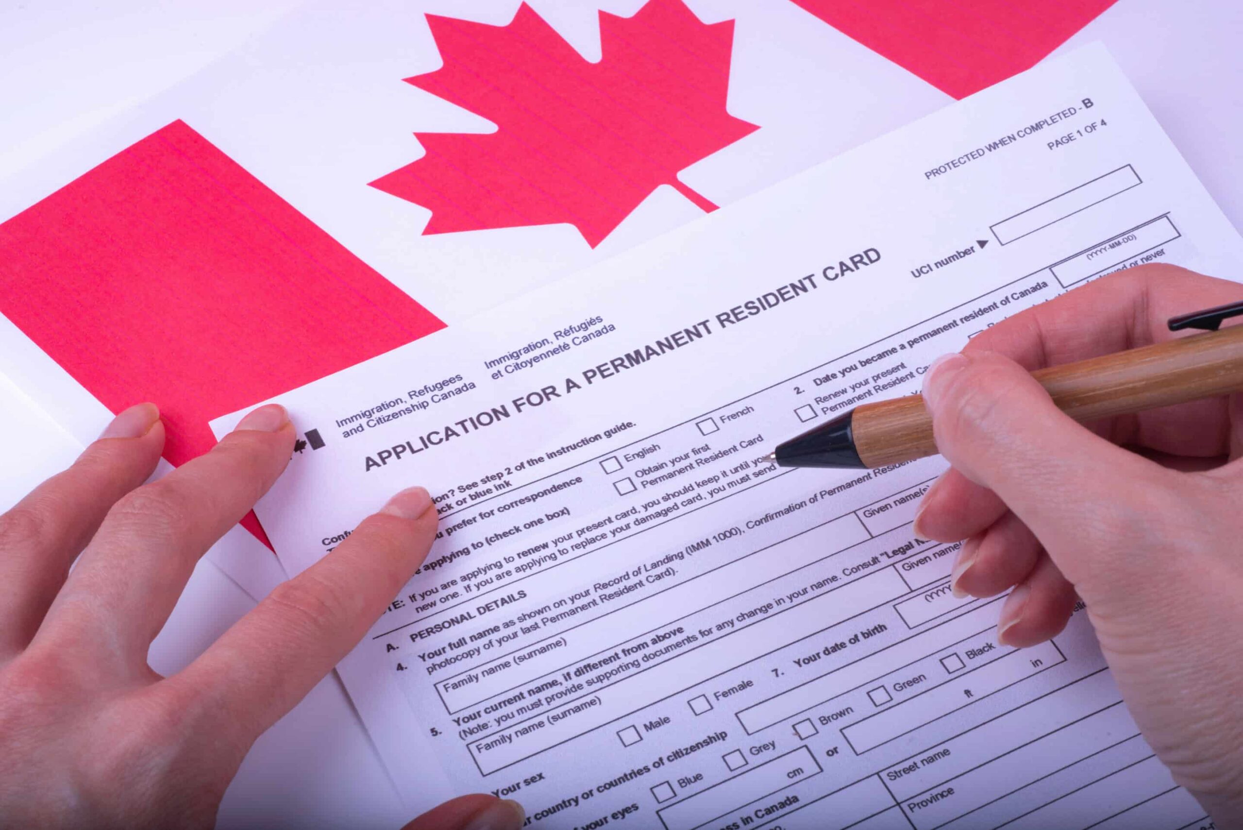 A person filling out an application for Canadian Permanent Residency.